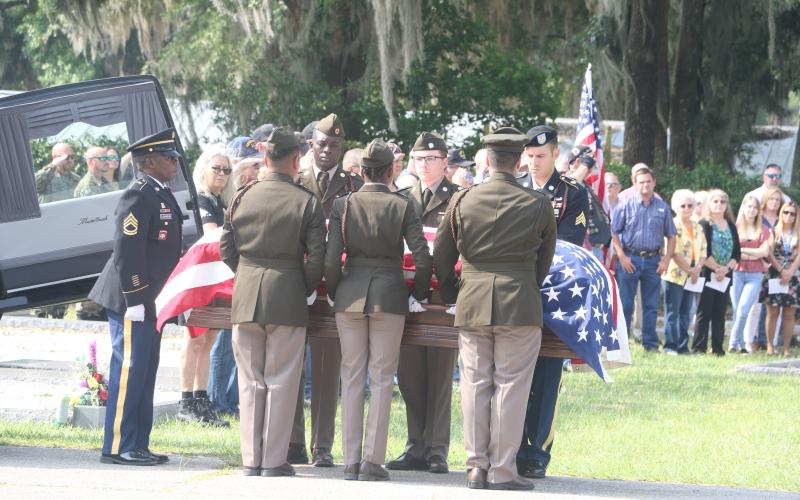 The casket of U.S. Army Cpl. Alton Christie is carried to his final resting place at Evergreen Cemetery in Jasper on Saturday morning. Hundreds of friends, family members and supporters gathered for Christie’s funeral. (MORGAN MCMULLEN/Lake City Reporter)