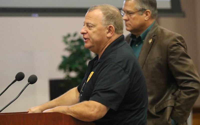 Lake City Police Chief Gerald Butler answers questions from the Columbia County Commission about consolidating dispatch Thursday as Sheriff Mark Hunter looks on. (JAMIE WACHTER/Lake City Reporter)