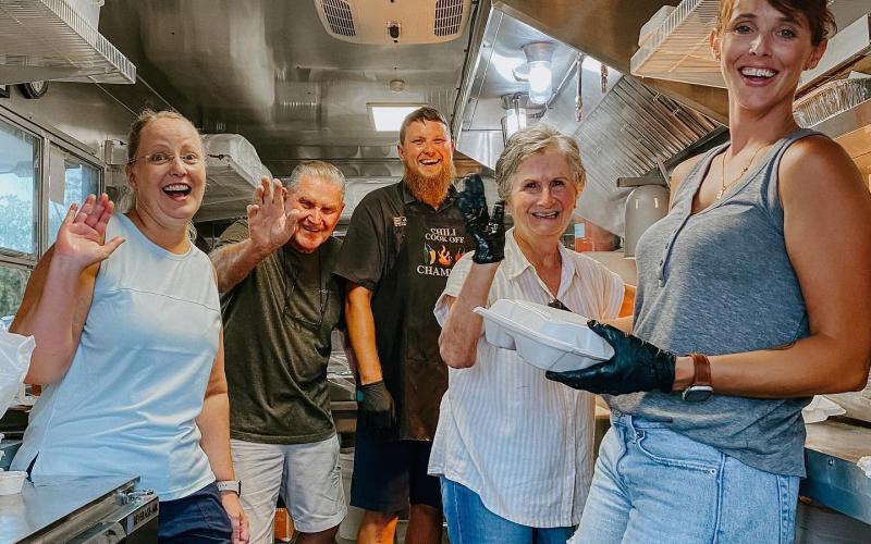 Robert and Emmie Chasteen sold their Chasteen’s Still Truckin’ food truck to Cammy and Ben Scott and Holly and Jonny Frazier. The rebranded truck, Cluckin’ and Truckin’ will hopefully start serving next week. The Chasteens helped Cammy Scott (left), Jonny Frazier (middle) and Holly Frazier (right) during a private event. (COURTESY)