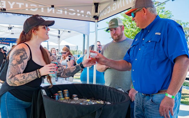 An Ancient City Brewing employee serves up a drink to a festivalgoer at last year’s Gateway City Craft Beer &amp; Wine Festival in downtown Wilson Park. (COURTESY)