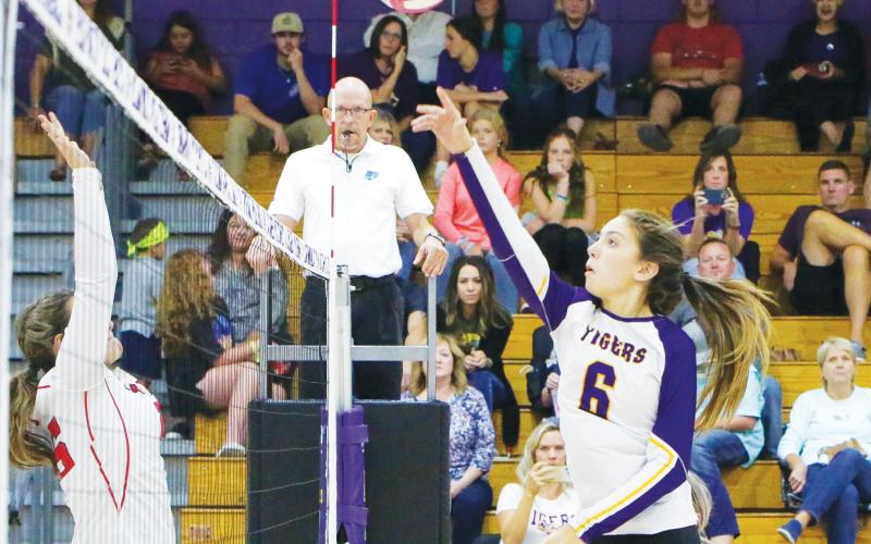 Columbia’s Sinei Wood hits a shot over the net against Fort White last season. (BRENT KUYKENDALL/Lake City Reporter)