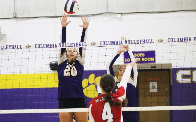 Columbia’s Cassidy O’Neal (20) and Avery Sandlin (right) try to block a shot from Baker County on Thursday night. (JORDAN KROEGER/Lake City Reporter)