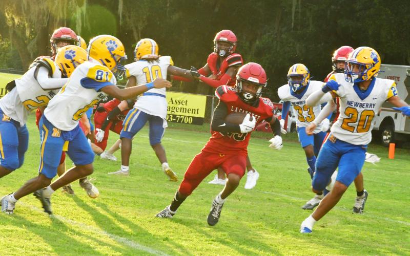 Lafayette’s Maurice Vought runs through the hole against Newberry during Friday night’s Preseason Classic. (ROB WOLFE/Special to the Reporter)