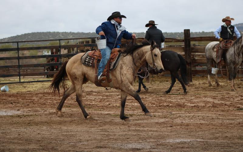 Jared Lee, a cowboy from Suwannee County, carries a bucket of water during a challenge on the fourth season of the ‘Ultimate Cowboy Showdown.’ The winner receives a herd of cattle as well as a belt buckle. (COURTESY INSP)