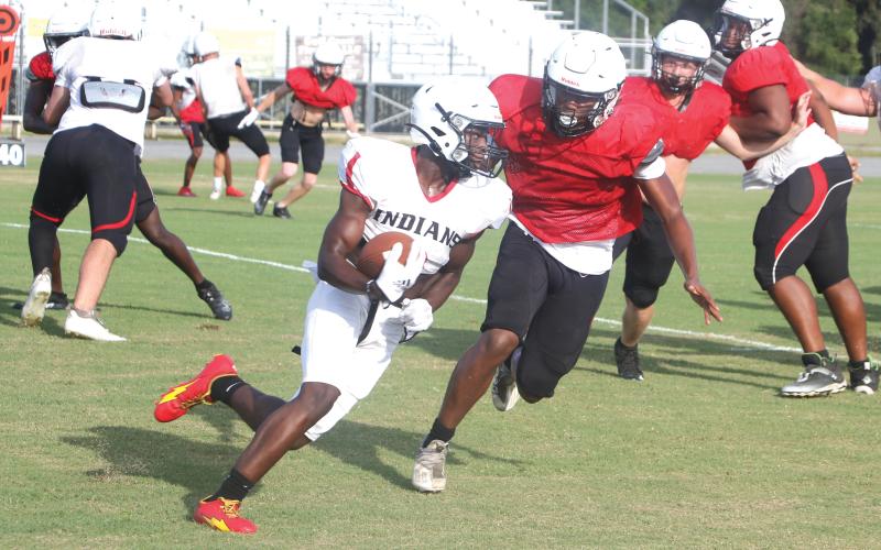 Fort White running back Dakota Fisher takes a carry up the field during Friday’s scrimmage. (MORGAN MCMULLEN/Lake City Reporter)