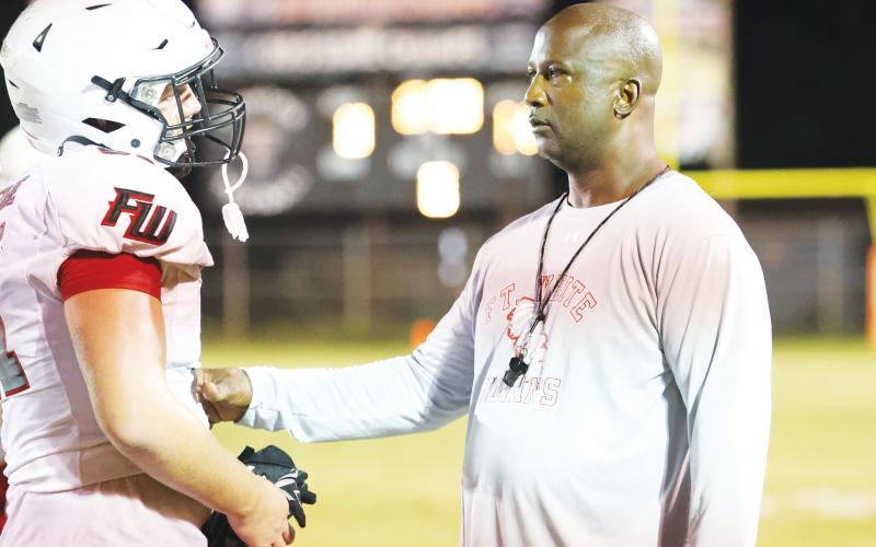 Fort White head coach Demetric Jackson talks with a player during Friday’s jamboree at Trenton. (PAUL BUCHANAN/Special to the Reporter)