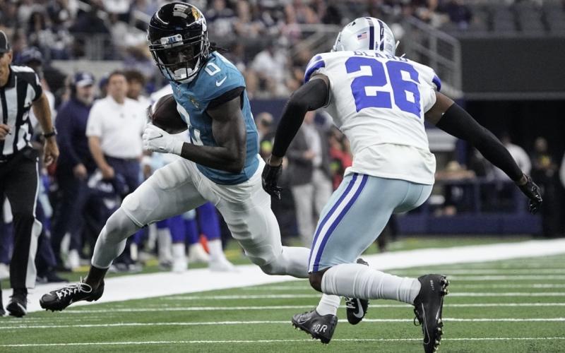 Jacksonville Jaguars wide receiver Calvin Ridley carries the ball against Dallas Cowboys cornerback DaRon Bland on Saturday in Arlington, Texas. (SAM HODDE/Associated Press)