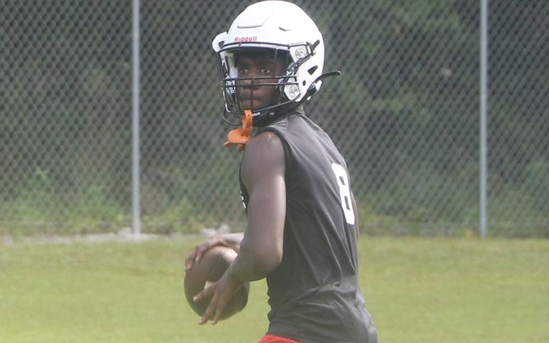 Fort White quarterback Jayden Jackson sets to throw a pass during Monday’s practice. (MORGAN MCMULLEN/Lake City Reporter)