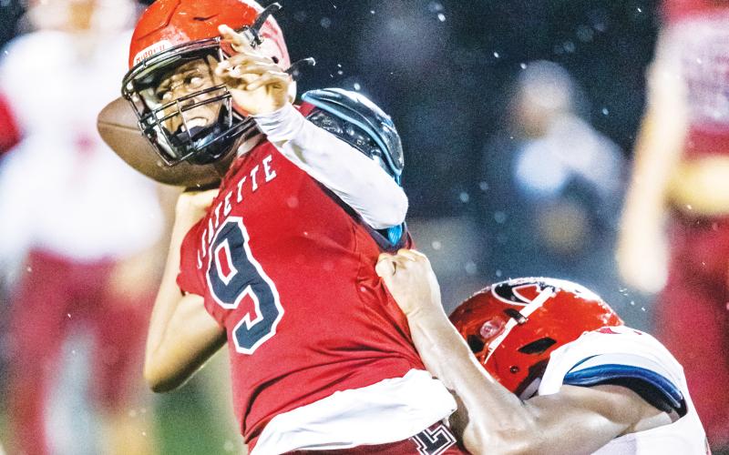 Lafayette quarterback Tywan Williamson throws a pass under pressure against Hamilton County last season. (FILE)