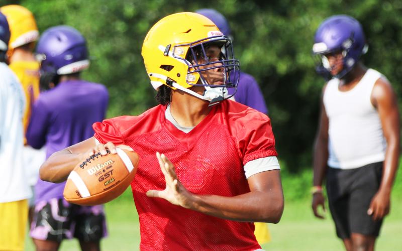 Columbia quarterback Zack Paulk drops back to pass during Monday’s practice. (JORDAN KROEGER/Lake City Reporter)
