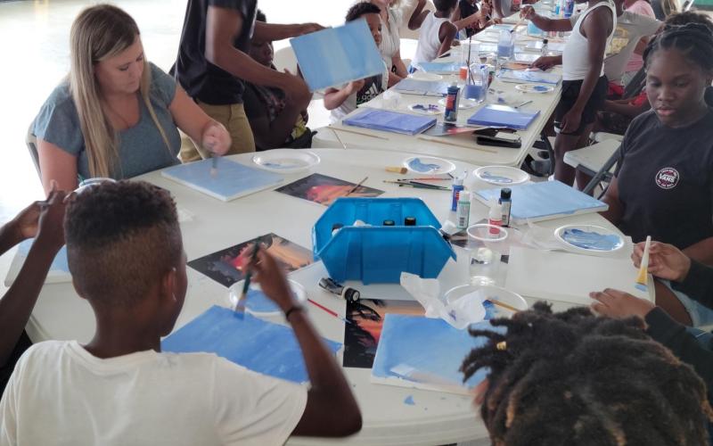 Children receive a painting lesson from Pedro Jermaine, a professional artist from Live Oak, during a Hands of Change event at Richardson Community Center. (COURTESY)