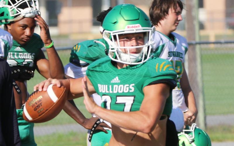 Suwannee quarterback Kodi Lang rolls out to throw a pass during Tuesday’s practice. (JAMIE WACHTER/Lake City Reporter)