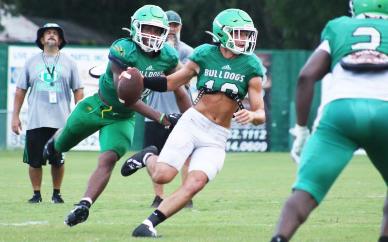 Suwannee defensive end Ja’Darius Cherry sacks quarterback Kodi Lang during Friday’s scrimmage. (JAMIE WACHTER/Lake City Reporter)