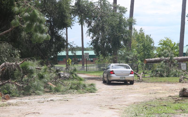 A road leading toward Suwannee High School is littered with fallen tree branches Thursday afternoon. Suwannee County Superintendent Ted Roush said there’s no definitive timeline for school to resume following Hurricane Idalia. (JAMIE WACHTER/Lake City Reporter)