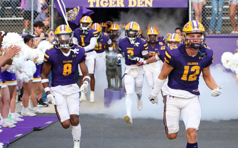 Columbia defensive back Markeyon Moore (8) and receiver Camdon Frier (12) lead their team on to the field prior to their game against Buchholz on Aug. 25. (BRENT KUYKENDALL/Lake City Reporter)