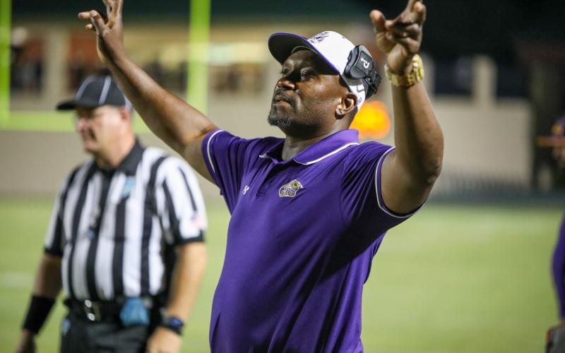Columbia head coach Brian Allen signals in a play to his offense during Friday’s game against DeLand. (BRENT KUYKENDALL/Lake City Reporter)
