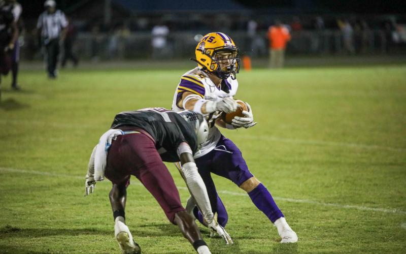 Columbia wide receiver Camdon Frier makes a move against a Madison County defender after a catch Friday night at Boot Hill. (BRENT KUYKENDALL/Lake City Reporter)