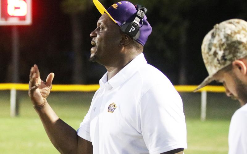 Columbia head coach Brian Allen signals a play into his team against Buchholz on Aug. 26. (JORDAN KROEGER/Lake City Reporter)