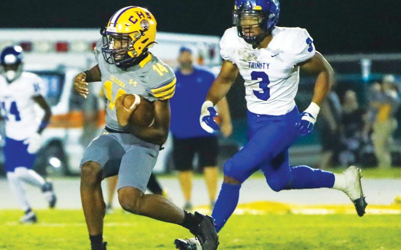 Columbia quarterback Xavier Collins scrambles up the field against Trinity Christian last Friday. (BRENT KUYKENDALL/Lake City Reporter)