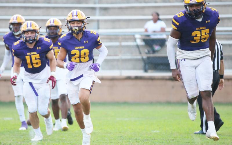 Columbia defensive back Julian De La Cruz (28) and linebacker Chris Jordan (35) celebrate after making a tackle on a kickoff return against Buchholz on Aug. 26.