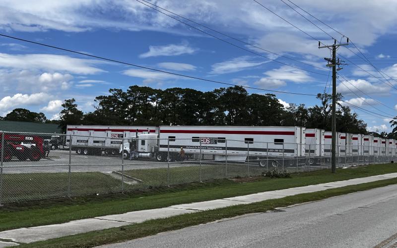 Trucks from Emergency Disaster Services line a parking lot at Suwannee High, which is serving as a mobile command center for the county’s emergency response. (JAMIE WACHTER/Lake City Reporter)