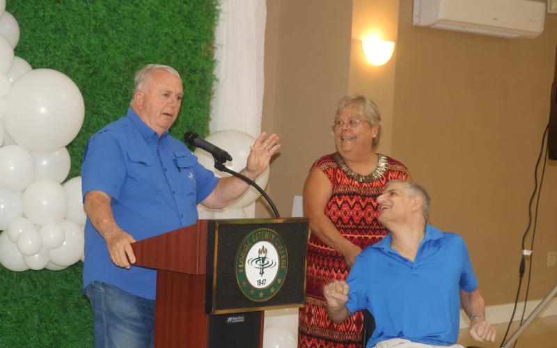 Gary Campbell (from left) addresses the audience at the United Way of Suwannee Valley fundraising kickoff event while accompanied by Beverly Standridge and his son, Michael Campbell. (TONY BRITT/Lake City Reporter)