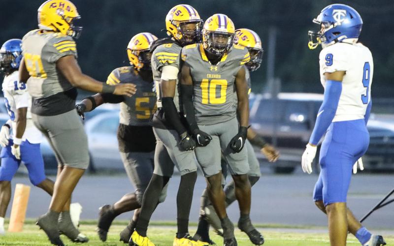 Columbia receiver Zamarion Jones celebrates with teammates after picking up yardage against Trinity Christian on Friday. (BRENT KUYKENDALL/Lake City Reporter)