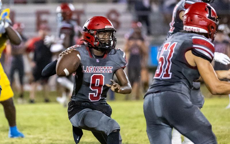 Lafayette quarterback Tywan Williamson scrambles to pass against Chiefland last Friday. (JACK HOWDESHELL/Special to the Reporter)