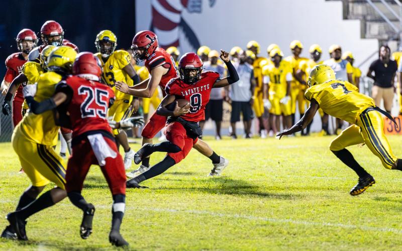 Lafayette quarterback Tywan Williamson scrambles up the field against Zarephath Academy last Friday. (JACK HOWDESHELL/Special to the Reporter)