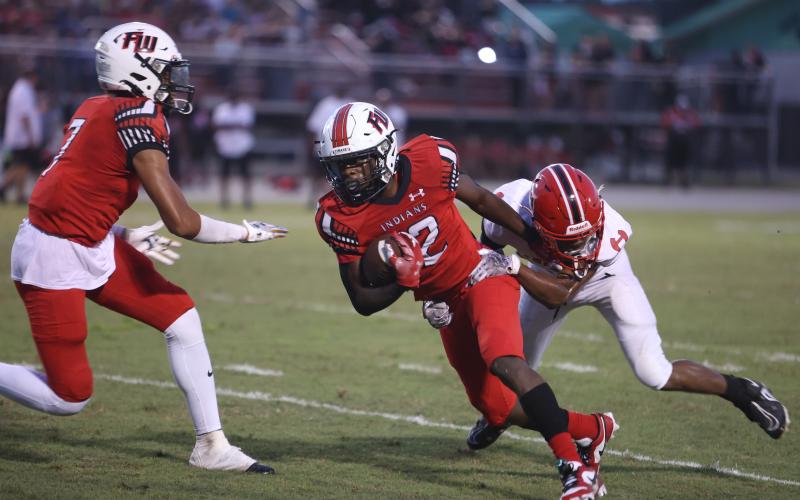 Fort White receiver Najeeb Smith looks to escape from a Hamilton County defender last Friday. (PAUL BUCHANAN/Special to the Reporter)