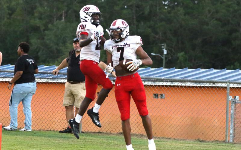 Fort White receivers Tafari Moe (7) and Najeeb Smith celebrate after Moe's third touchdown reception Monday night at Jefferson County. (MORGAN MCMULLEN/Lake City Reporter)