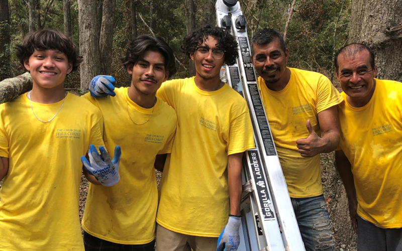 Daniel Mora, Elvis Reynolds, Ammon Reyes, Virginio Mora and Martin Mora are all smiles after helping clear debris from a group of homes for disabled individuals. (COURTESY)