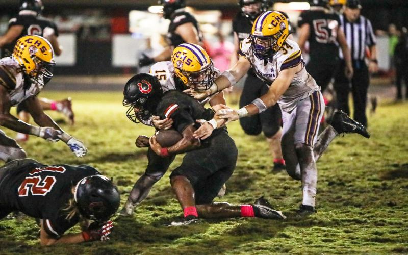 Columbia linebacker Tyson Yaxley (15) and defensive lineman Kyten Davis (34) make a tackle against Middleburg on Friday. (BRENT KUYKENDALL/Lake City Reporter)