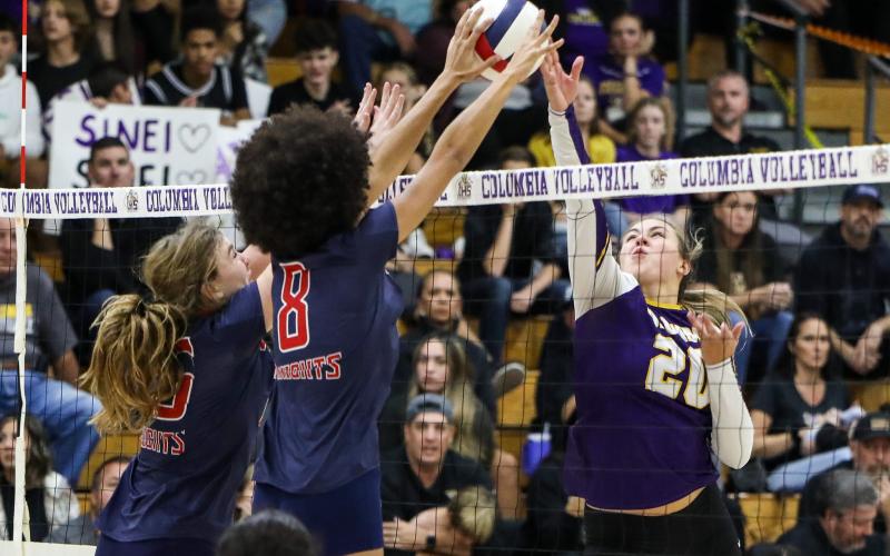 Columbia middle hitter Cassidy O’Neal gets blocked by Vanguard middle hitter Lillian Hart during Tuesday’s District 2-5A semifinal. (BRENT KUYKENDALL/Lake City Reporter)