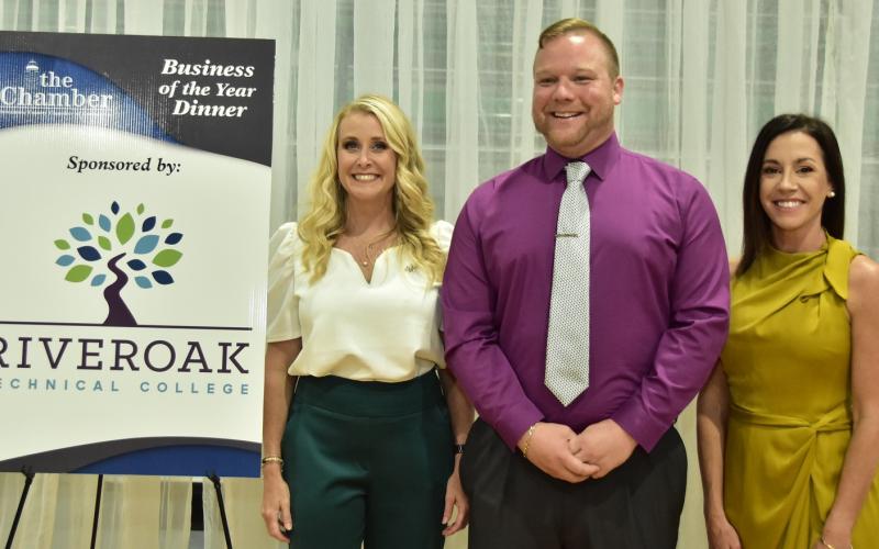RIVEROAK Technical College’s TJ Vickers, who shoots video commercials for all the finalists, is pictured with Suwannee County Chamber of Commerce Executive Director Hilary Cannon (left) and President Hannah Skinner at last year’s Business of the Year dinner. (FILE)