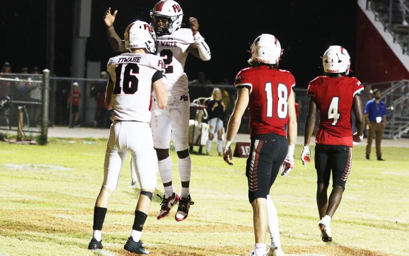 Fort White receiver Najeeb Smith celebrates with receiver Garrett Brady after Brady scored a touchdown against Hilliard on Friday night. (MORGAN MCMULLEN/Lake City Reporter)