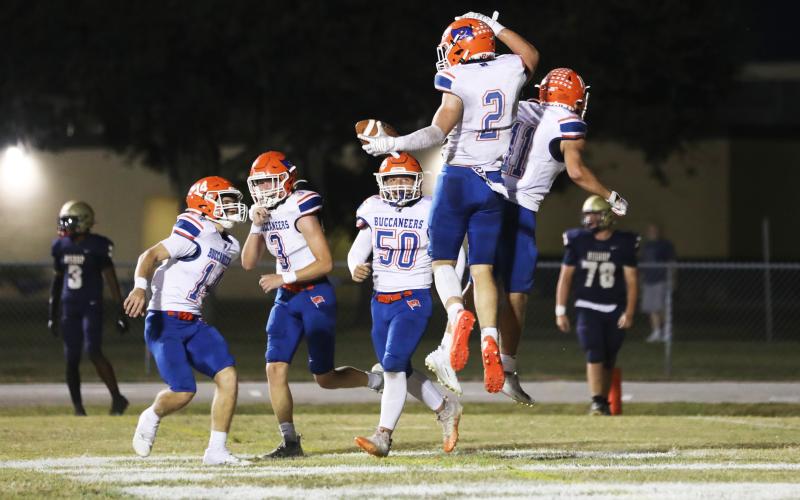 Branford running back Trevor Maddox (2) celebrates with teammates after scoring a touchdown against Bishop McLaughlin Catholic on Friday. (ERIN ROBERTS/Special to the Reporter
