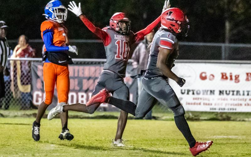 Lafayette’s Jalen Hill scores a touchdown against Taylor County while Jordan Murphy (10) celebrates on Tuesday night. (JACK HOWDESHELL/Special to the Reporter)