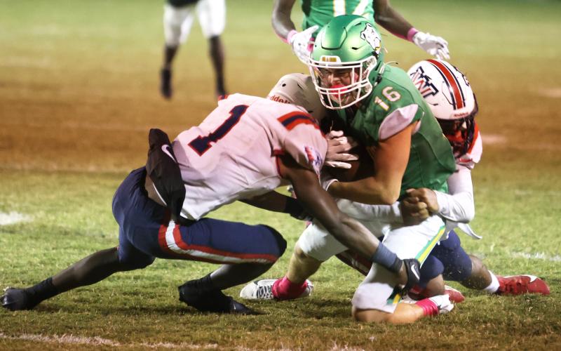 Suwannee receiver Noah Lopez is tackled by Wakulla safety Jeremiah Thomas and another defender on Friday. (PAUL BUCHANAN/Lake City Reporter)