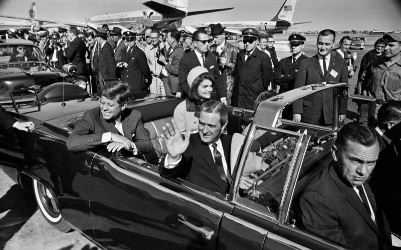 President John F. Kennedy (back left), Jacqueline Kennedy (back right), begin the motorcade from Love Field to downtown Dallas on Nov. 22, 1963. Texas Gov. John Connally is waving. (TOM DILLARD/Dallas Morning News/TNS/file)