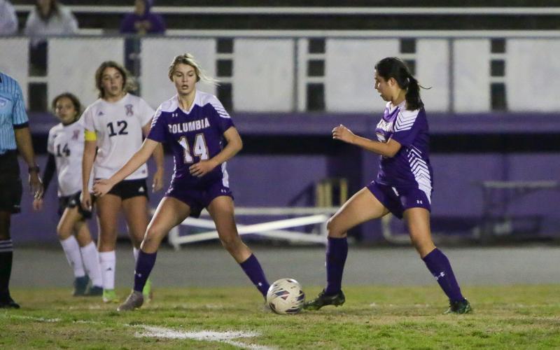 Columbia's Carla Medina-Rodriguez (right) passes the ball to Mia Brasel (14) during a game against Middleburg last season. (FILE)