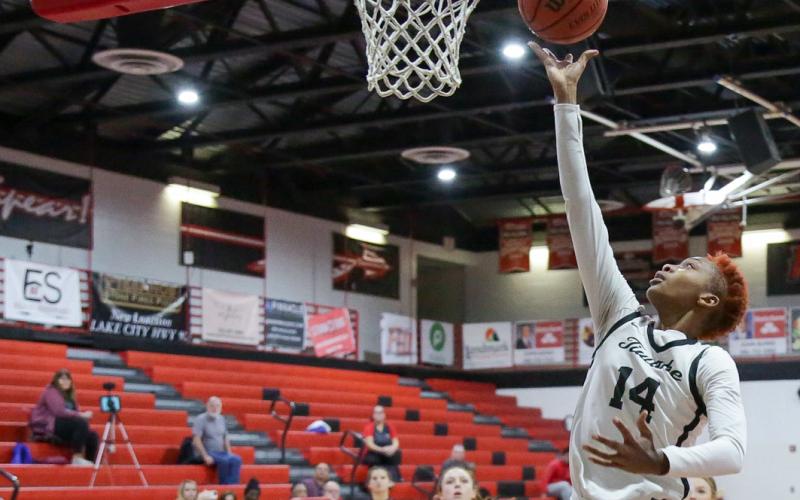 Fort White forward Isreal Hart makes a layup against Branford last season. (FILE)