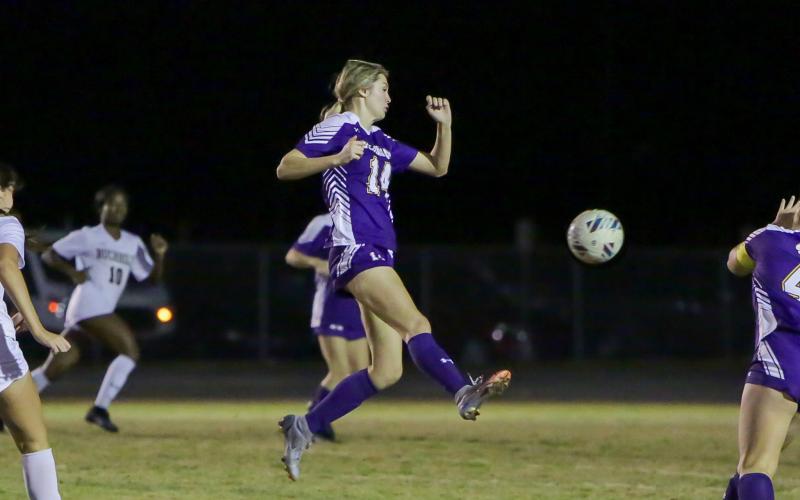 Columbia's Mia Brasel passes the ball up the field in a match against Buchholz last season. (BRENT KUYKENDALL/Lake City Reporter)
