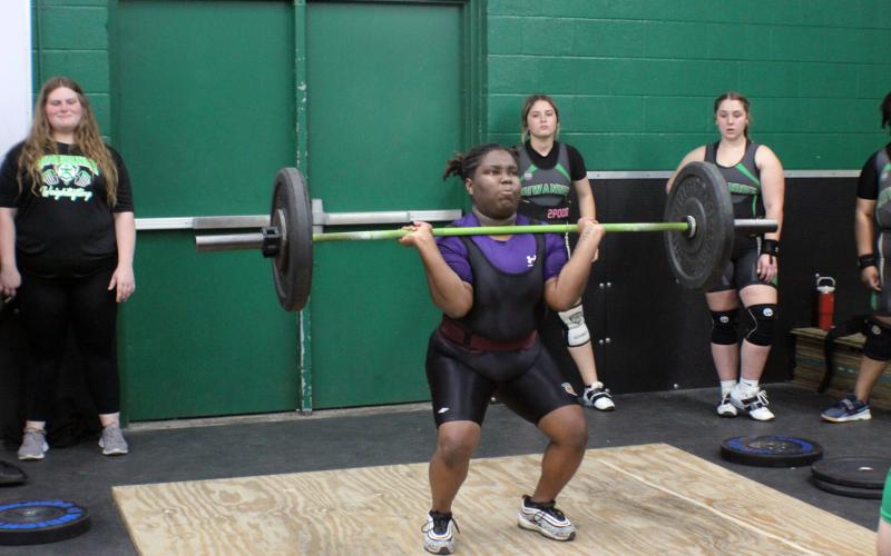 Columbia lifter Amaya Hawkins performs the clean and jerk during Monday's meet against Suwannee. (COURTESY)