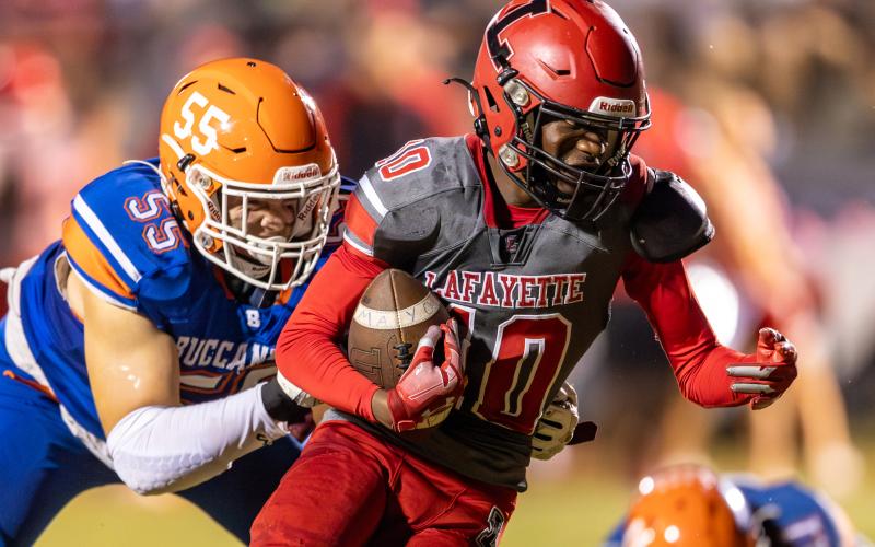 Lafayette receiver Jordan Murphy tries to escape a tackle from Branford defensive lineman Tate Dampier on Sept. 29. (JACK HOWDESHELL/Special to the Reporter)