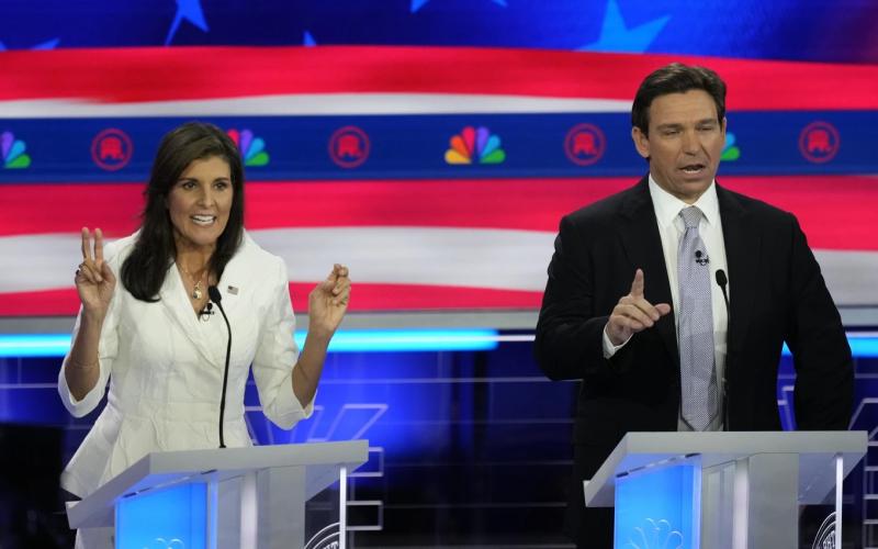 Former U.N. Ambassador Nikki Haley and Florida Gov. Ron DeSantis talk during a Republican presidential primary debate on Wednesday at the Adrienne Arsht Center for the Performing Arts of Miami-Dade County in Miami. (REBECCA BLACKWELL/Associated Press)