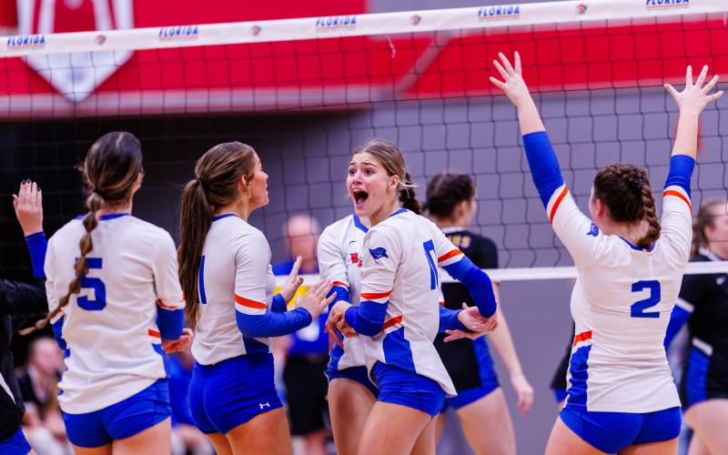 Branford outside hitter Kayley Johnson (middle) celebrates with teammates after a lull against Newberry during the Class 1A state semifinals on Monday at Polk State College. (JACK HOWDESHELL/Special the Reporter)