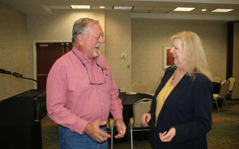 Konnie Patke, the lone finalist for the vacant executive director spot with the Columia County Tourist Development Council, shares a laugh with Carl King at Wednesday’s meet-and-greet event. (TONY BRITT/Lake City Reporter)