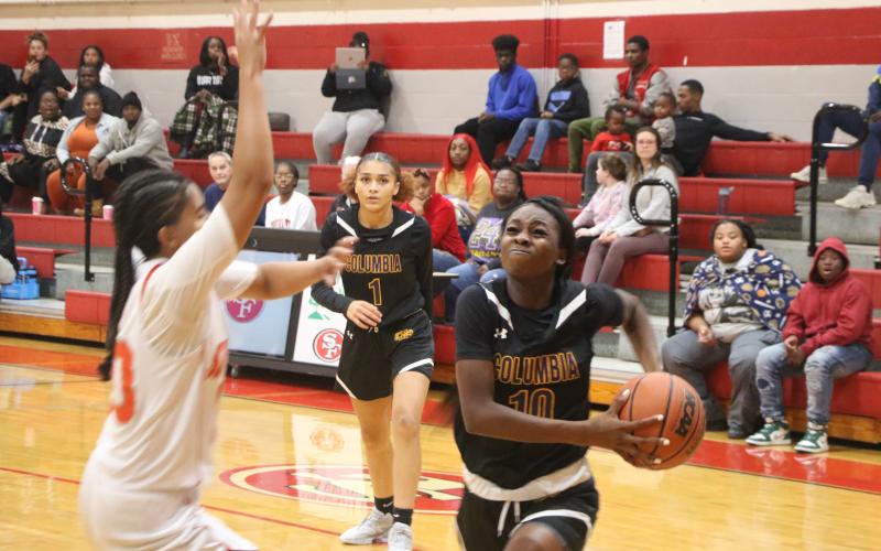 Columbia guard Ayesha Broxey (10) drives to the basket as guard Mariah Cox looks on from the background in the first half of Wednesday’s win over Santa Fe. (MORGAN MCMULLEN/Lake City Reporter)