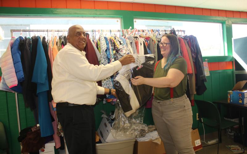 Philip Mobley (left), NorthStar Family Resource Center executive director, hangs clothing at the facility in January with help from Christen Lancaster, NorthStar Community Center Community Research Coordinator. (FILE)